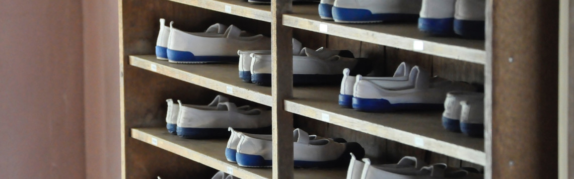Self-service rack with available pairs of bowling shoes